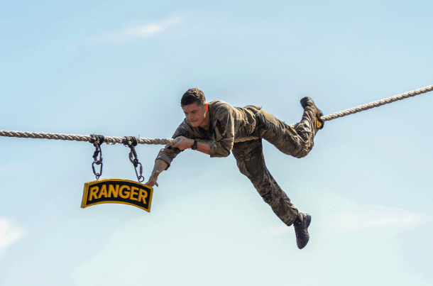 Army Ranger navigating a rope course, demonstrating discipline, focus, and readiness under pressure.