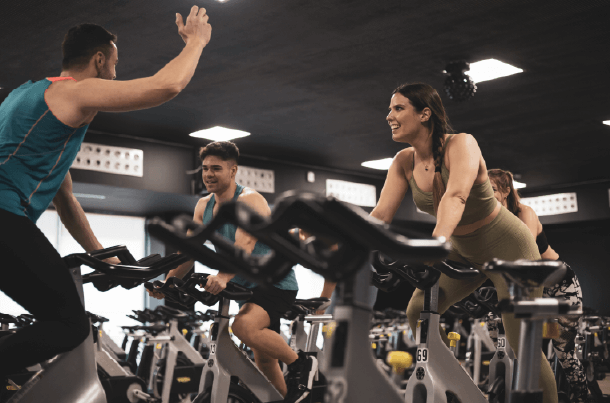 A group of veterans participates in an energetic spin class, fostering camaraderie and resilience. Demonstrating that, just like fitness, being prepared with life insurance from USBA is a strong way to safeguard what matters.