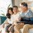 Family sitting together at home discussing finances, representing conversations about life insurance and planning for the future.