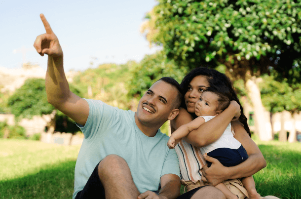 A young military family enjoying time together outside, reflecting financial planning and life insurance as part of long-term readiness.