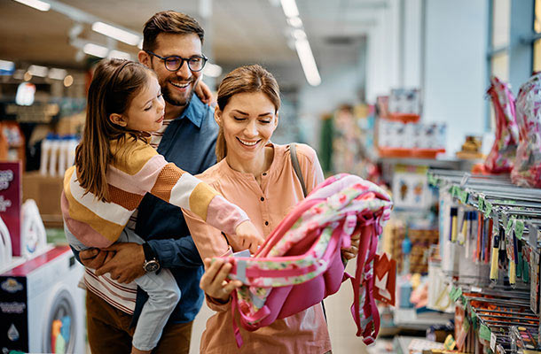 Military family shopping for a child&qts backpack during back-to-school season, illustrating smart budgeting choices