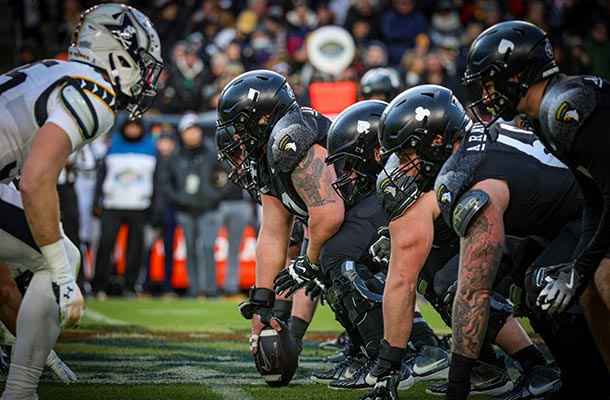 Army and Navy football teams face off at the line of scrimmage during the 2024 game-symbolizing the historic bond between American sports and military tradition