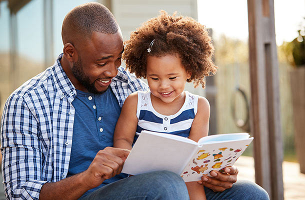 Financial literacy for USBA service members- Dad and daughter reading book