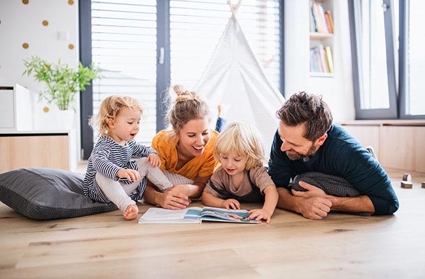 Military family reading together at home-reminding us that Life Insurance Awareness Month is about protecting what matters most.