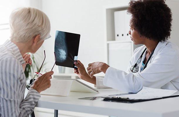 Doctor reviews scan results with a patient, representing the importance of early cancer detection and TRICARE-covered testing options like the Galleri test